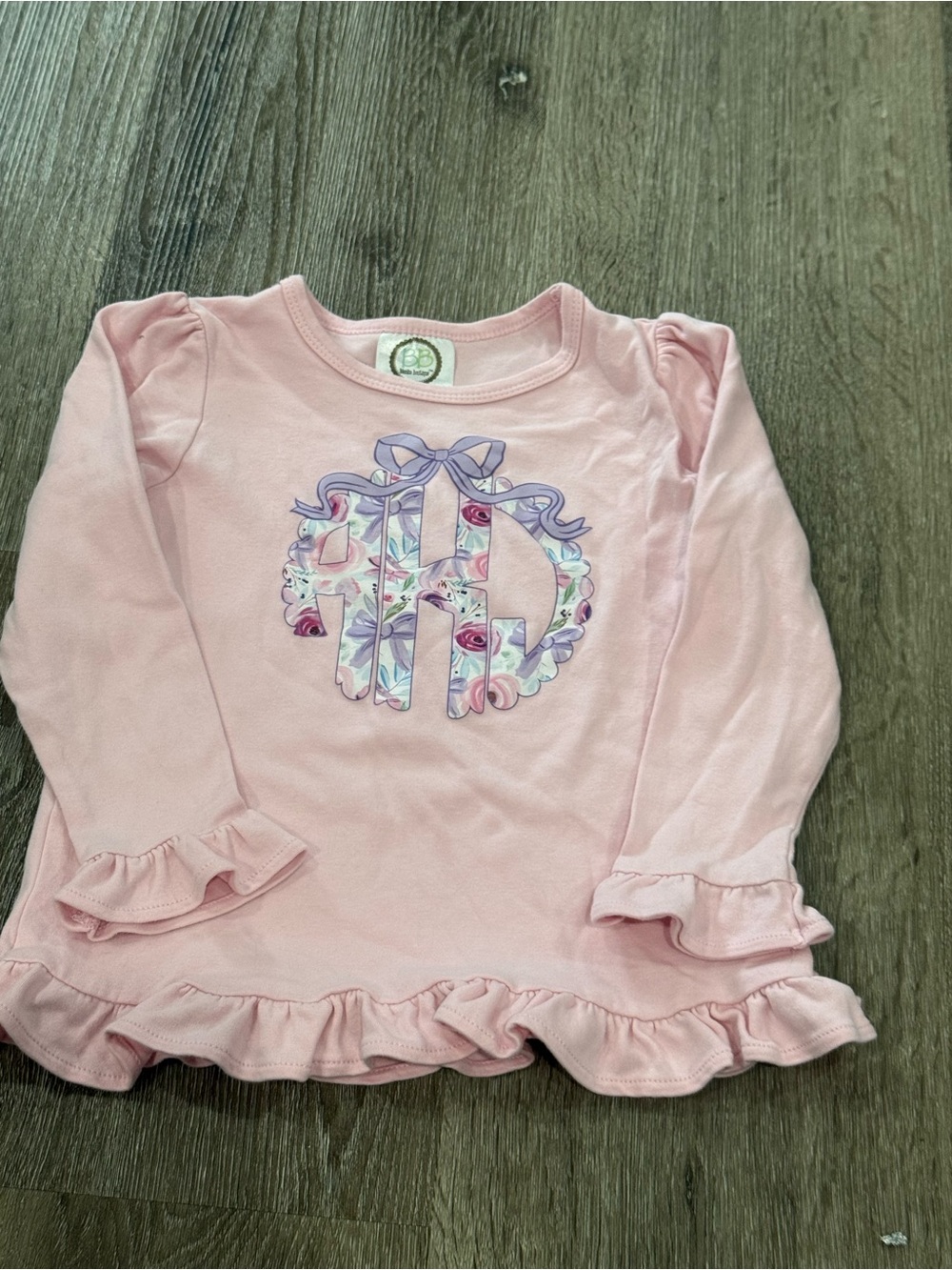Pink Girls' Long-Sleeve Ruffle Hem Top with Floral Monogram